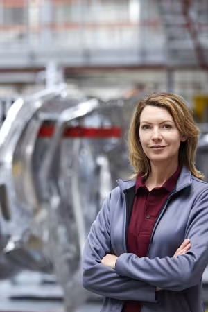 Photo of woman in front of assembly line